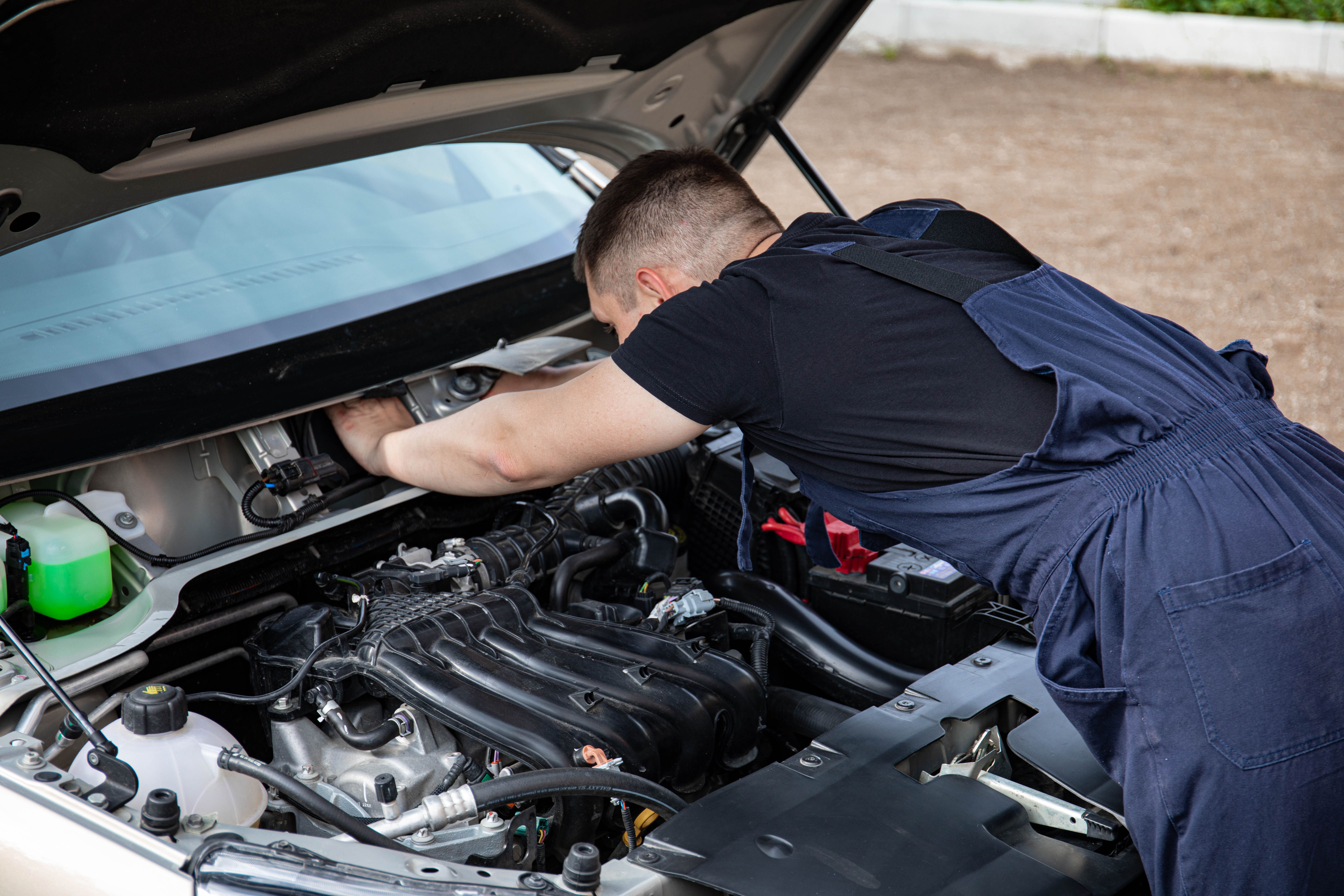 Mechanic inspecting an engine bay